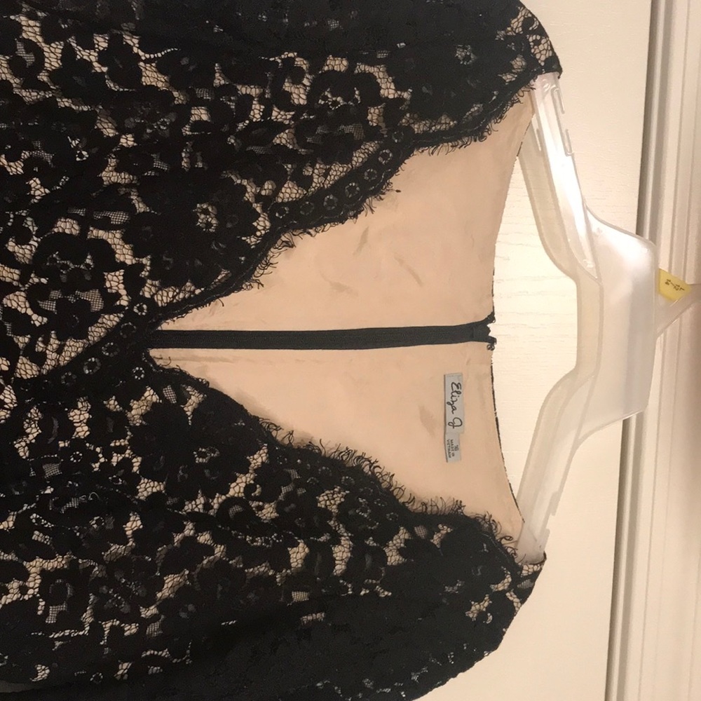 A midi black dress with lace or net.